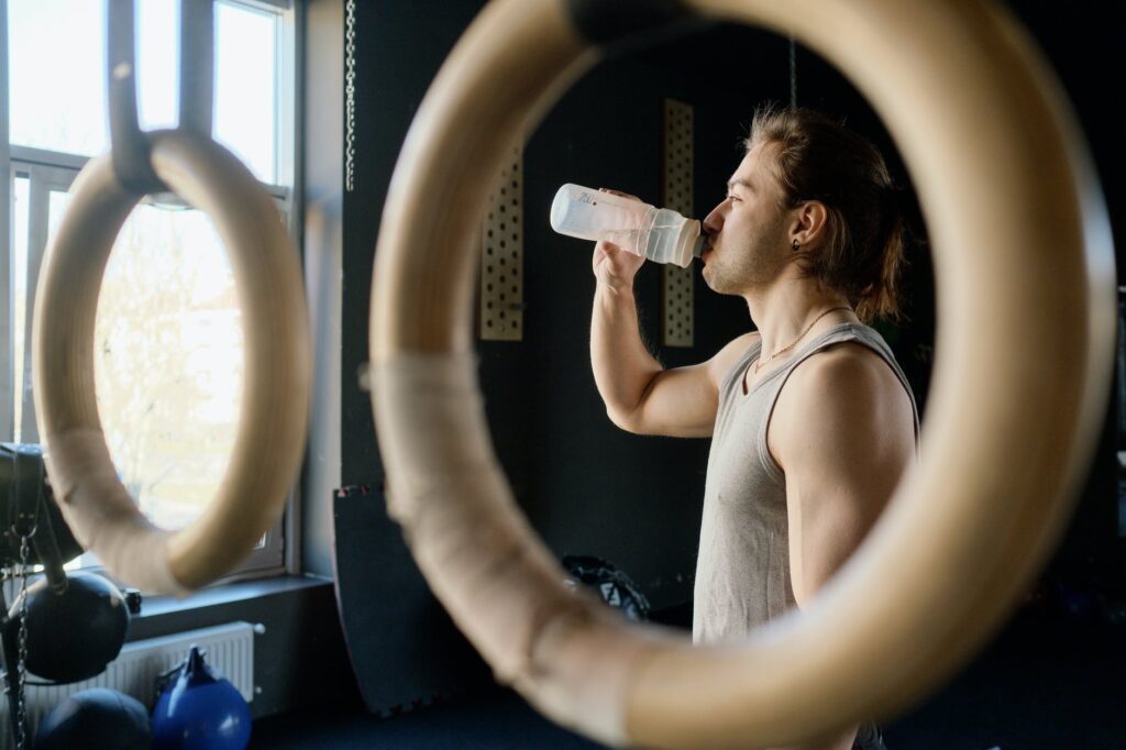 man drinking from water bottle