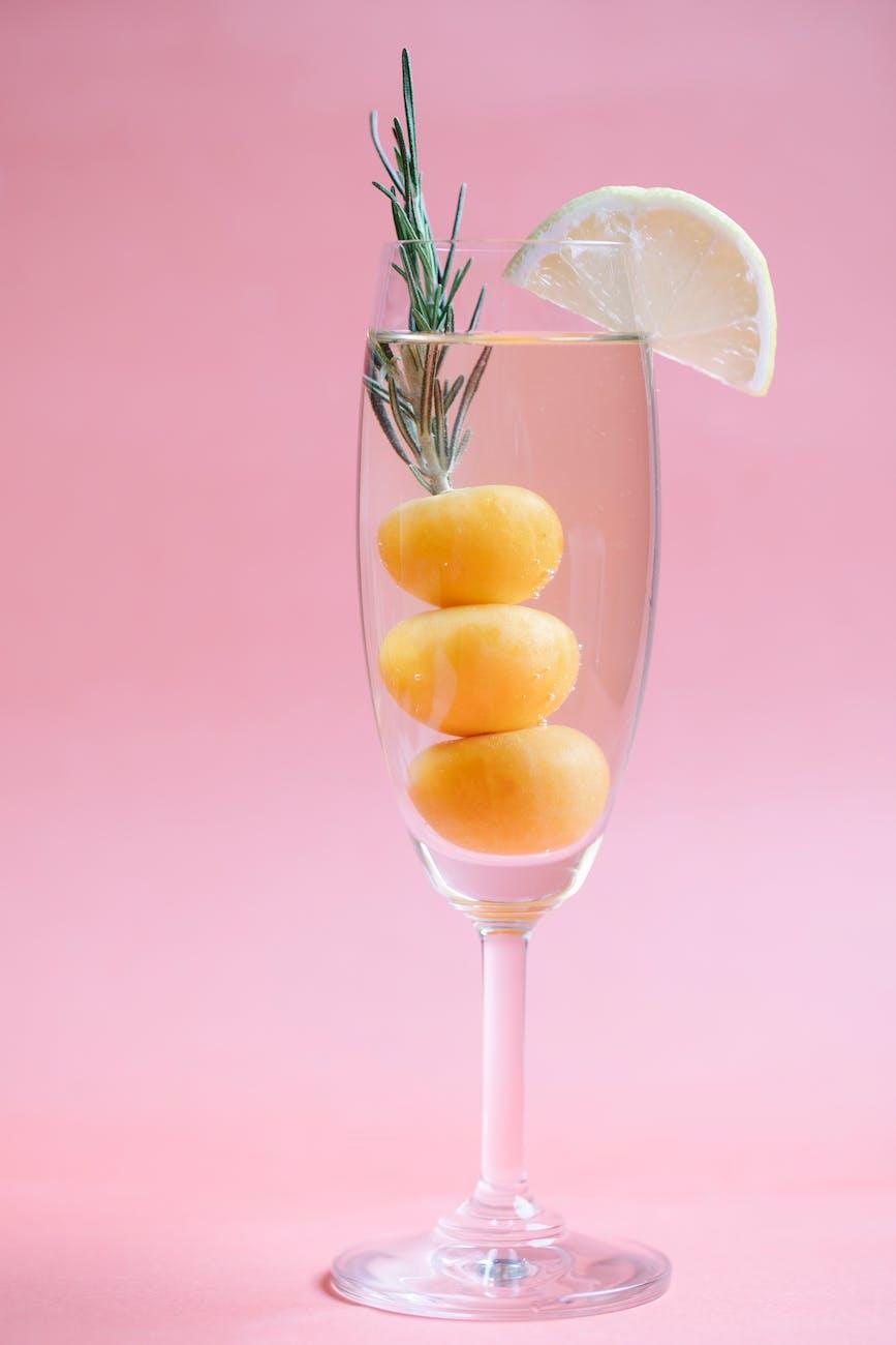glass of fresh cocktail with lemon and kumquat