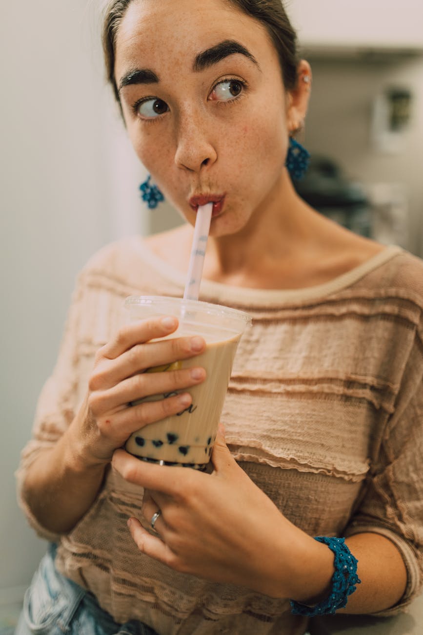 woman drinking bubble tea Photo by RODNAE Productions on Pexels.com bubble tea day