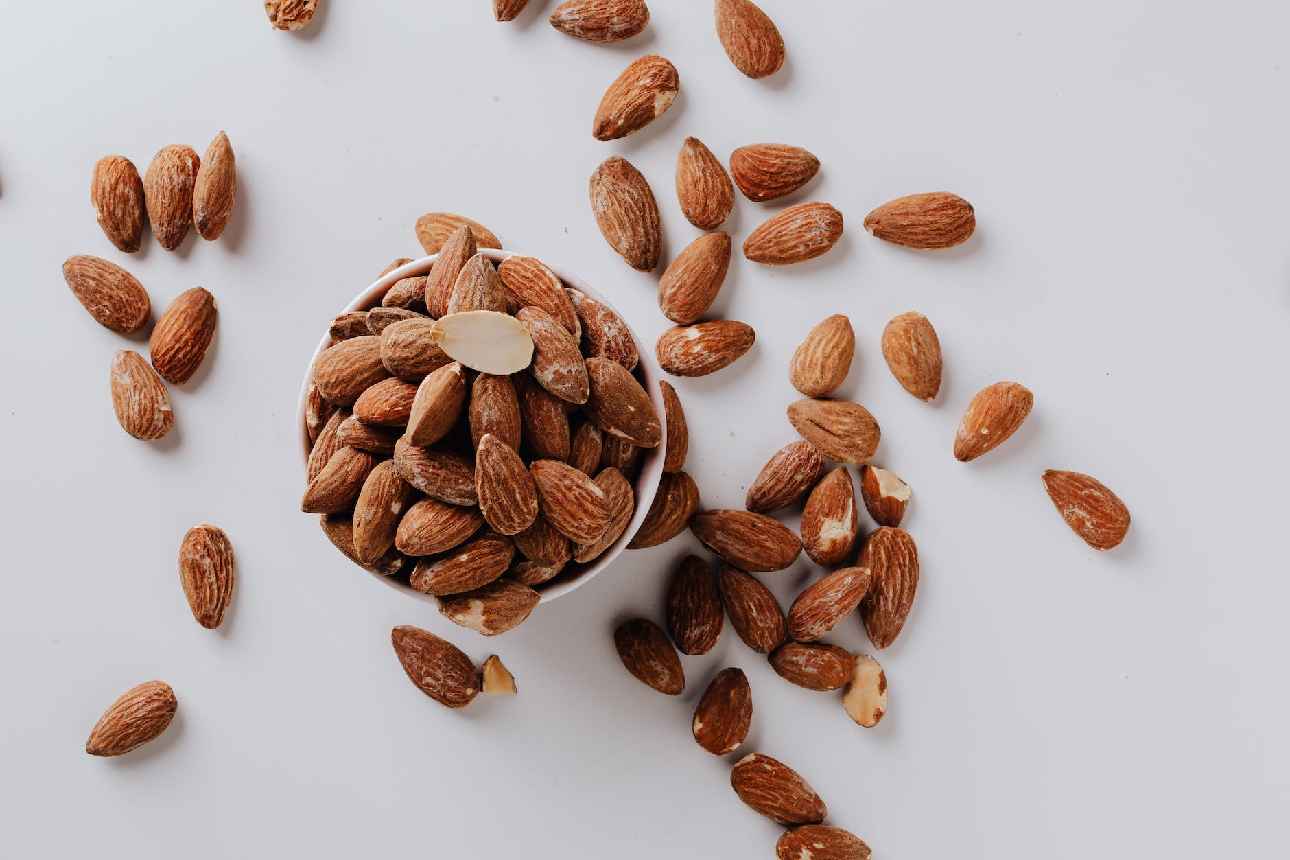 bowl filled with raw almond nuts on white background Photo by Karolina Grabowska on Pexels.com